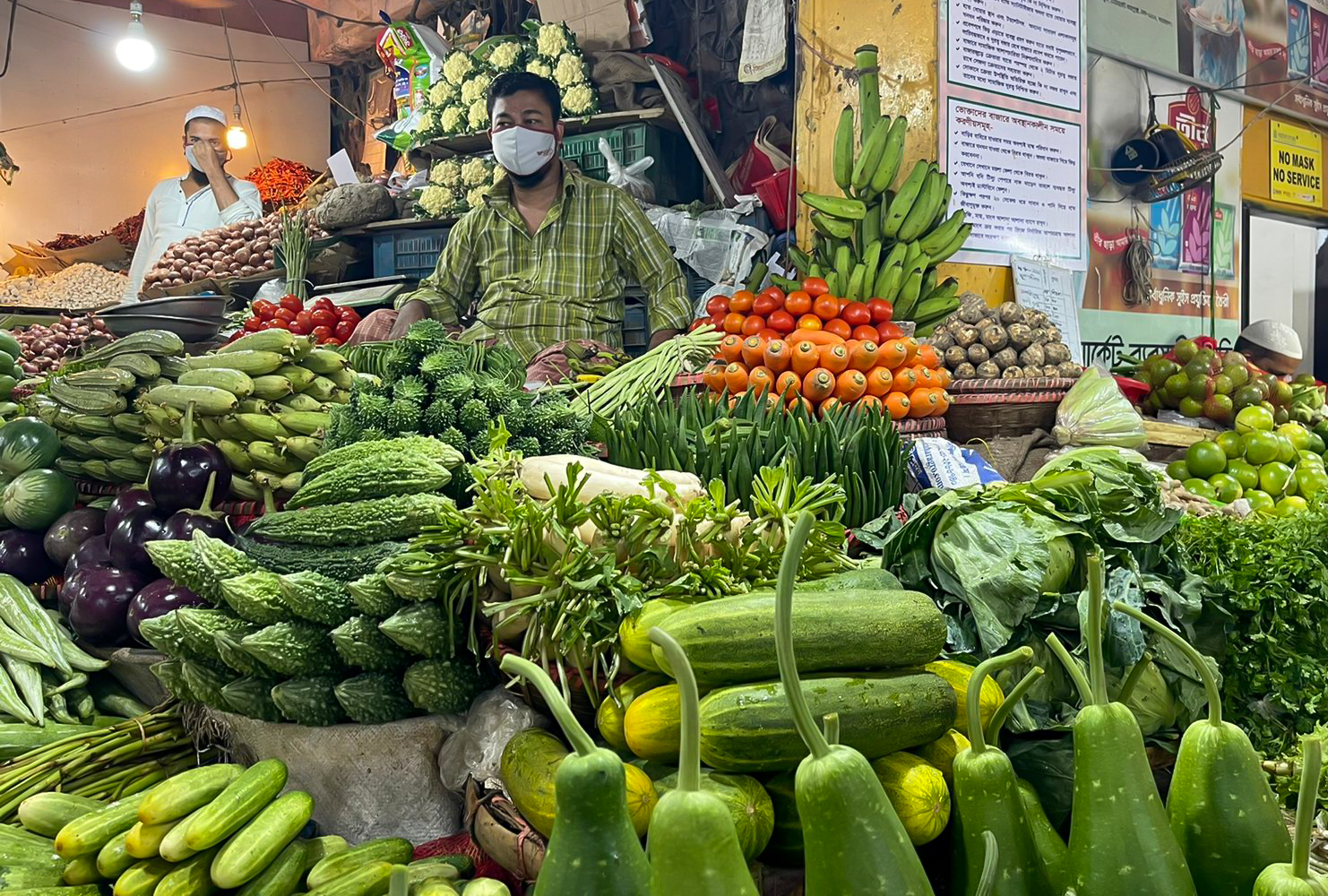 Two men selling fruits and vegetables