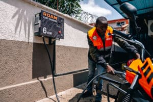 Copy of 0.Boda boda Rider charging a Roam Air light electric vehicle at a Roam Point in Waiyaki Way