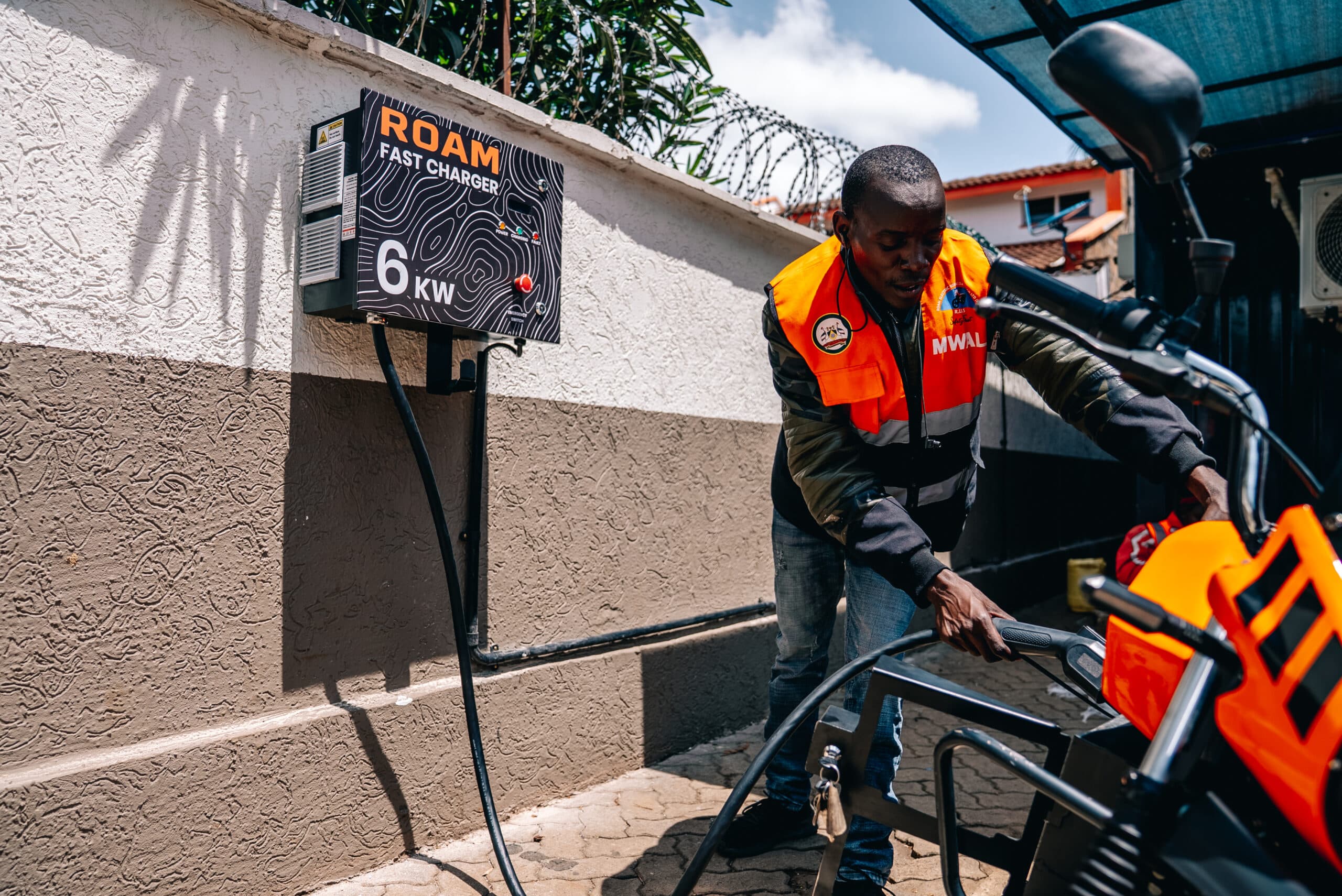 Copy of 0.Boda boda Rider charging a Roam Air light electric vehicle at a Roam Point in Waiyaki Way scaled